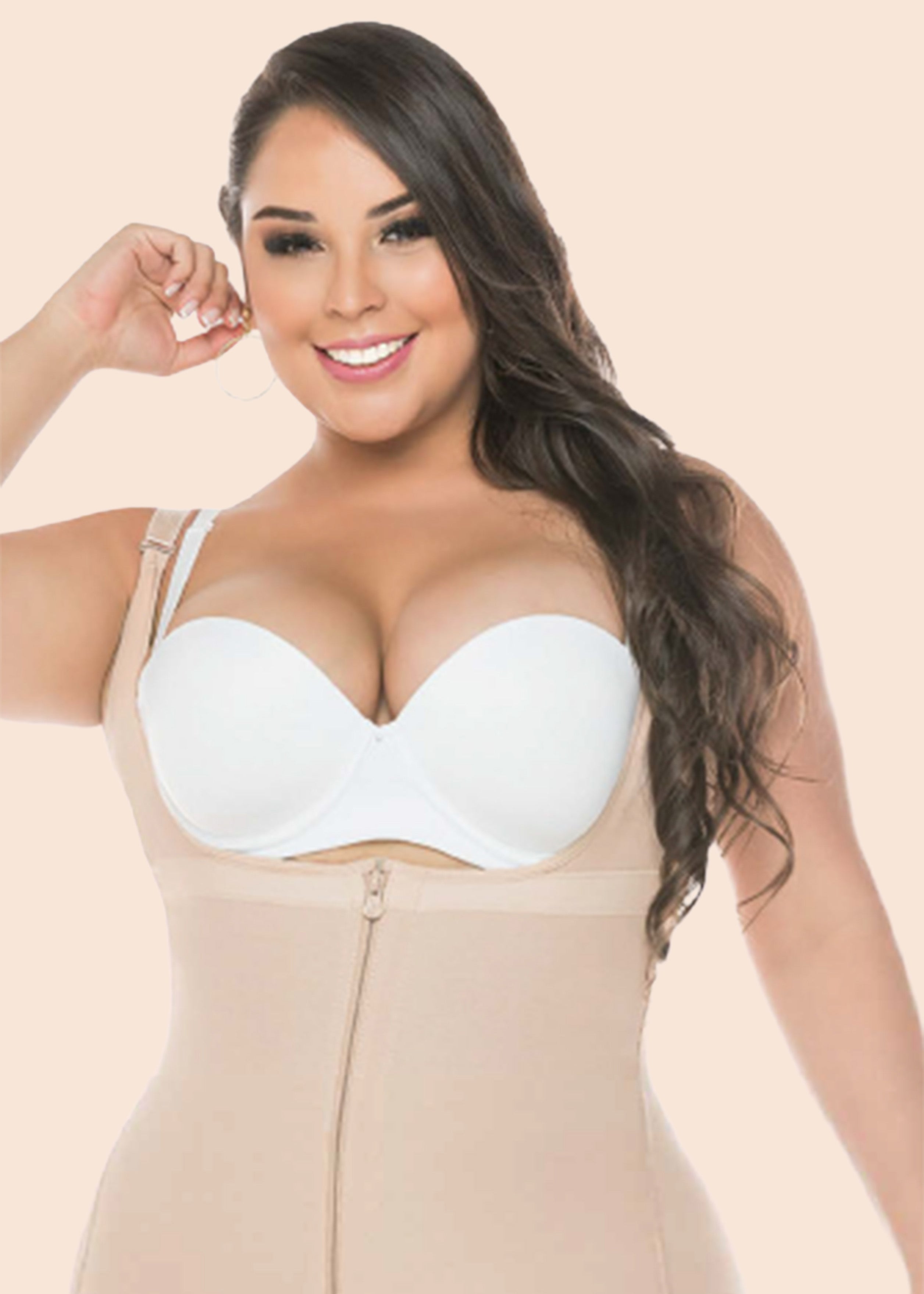 Woman wearing a beige shapewear garment against a beige background