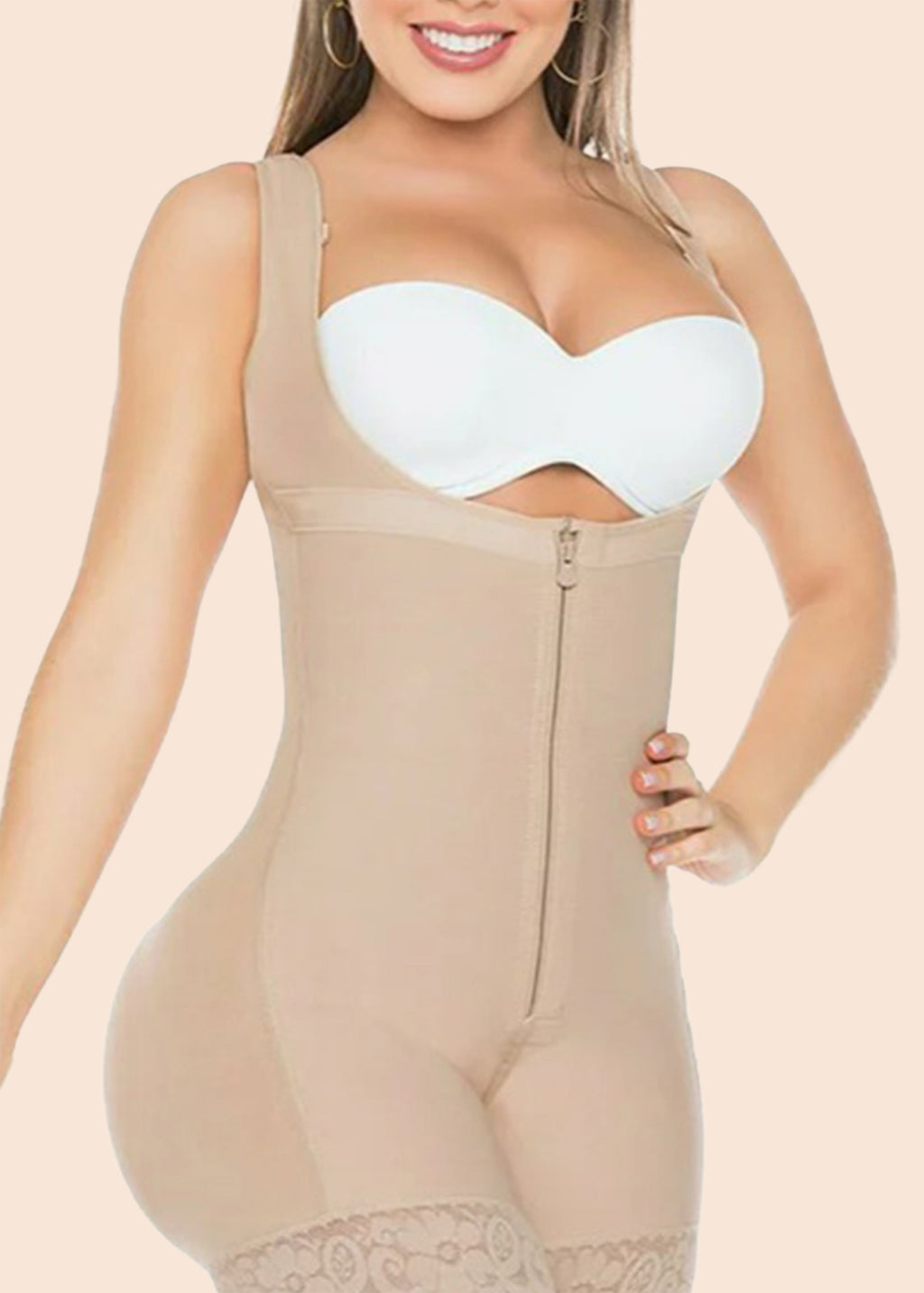Woman wearing a beige shapewear garment with a white bra underneath on a beige background