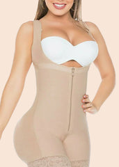 Woman wearing a beige shapewear garment with a white bra underneath on a beige background