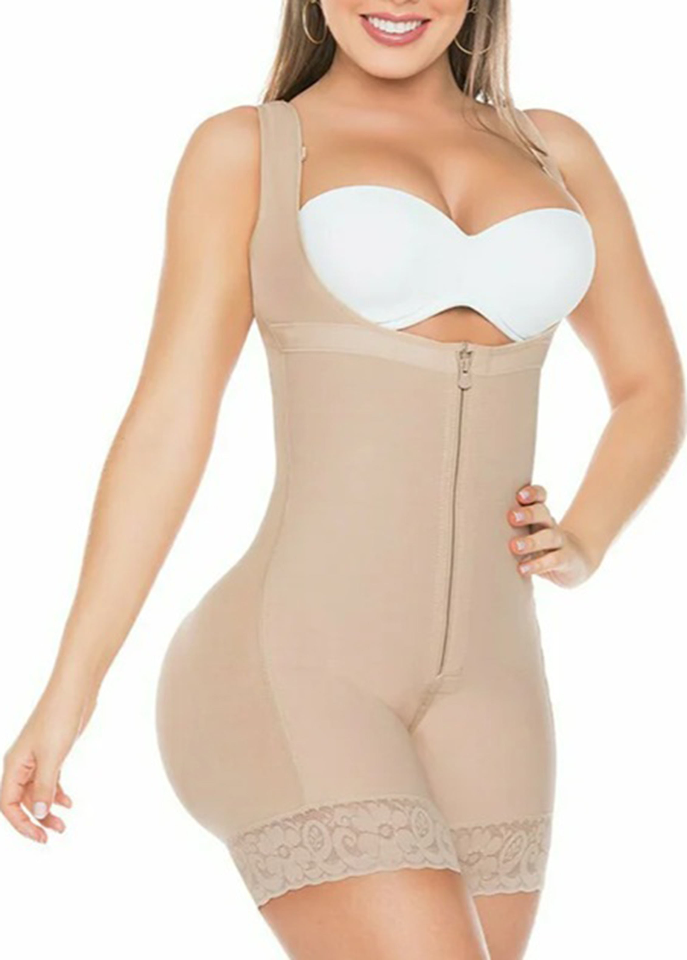 Woman wearing a beige shapewear bodysuit with a white bra on a white background