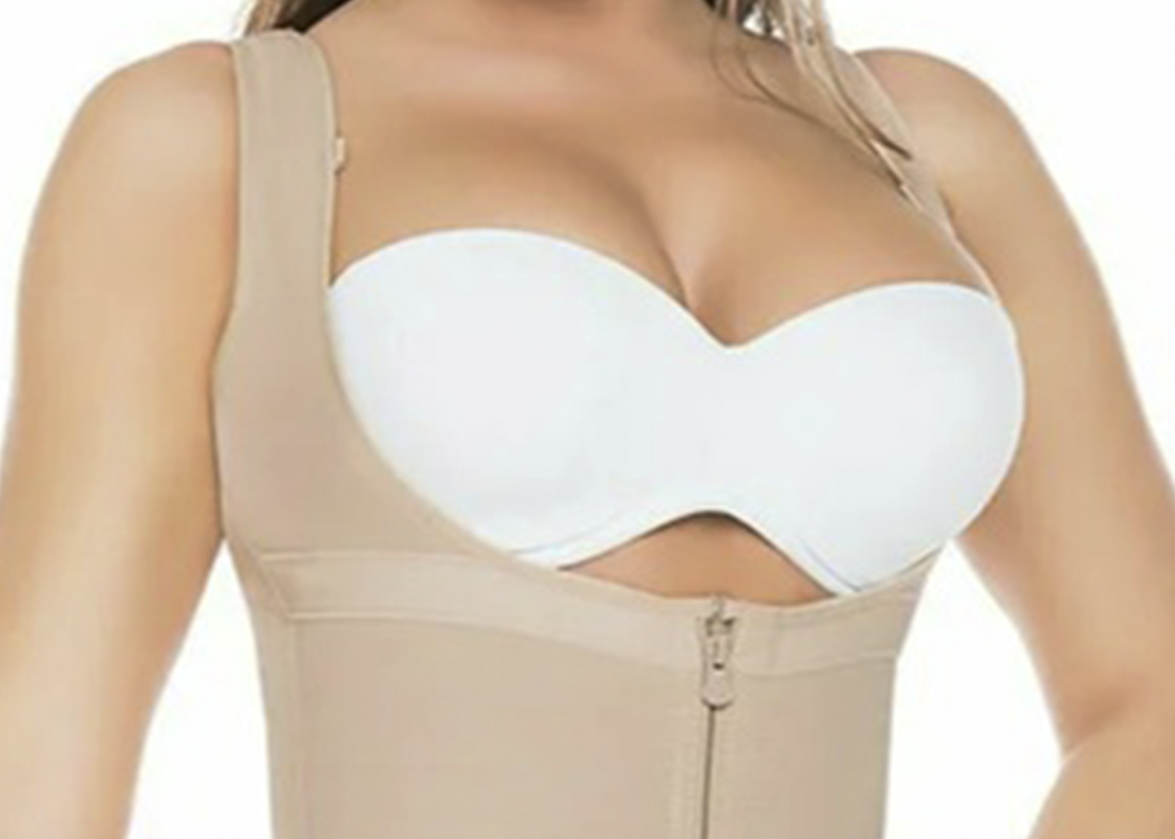 White strapless bra worn under a beige shapewear garment on a white background
