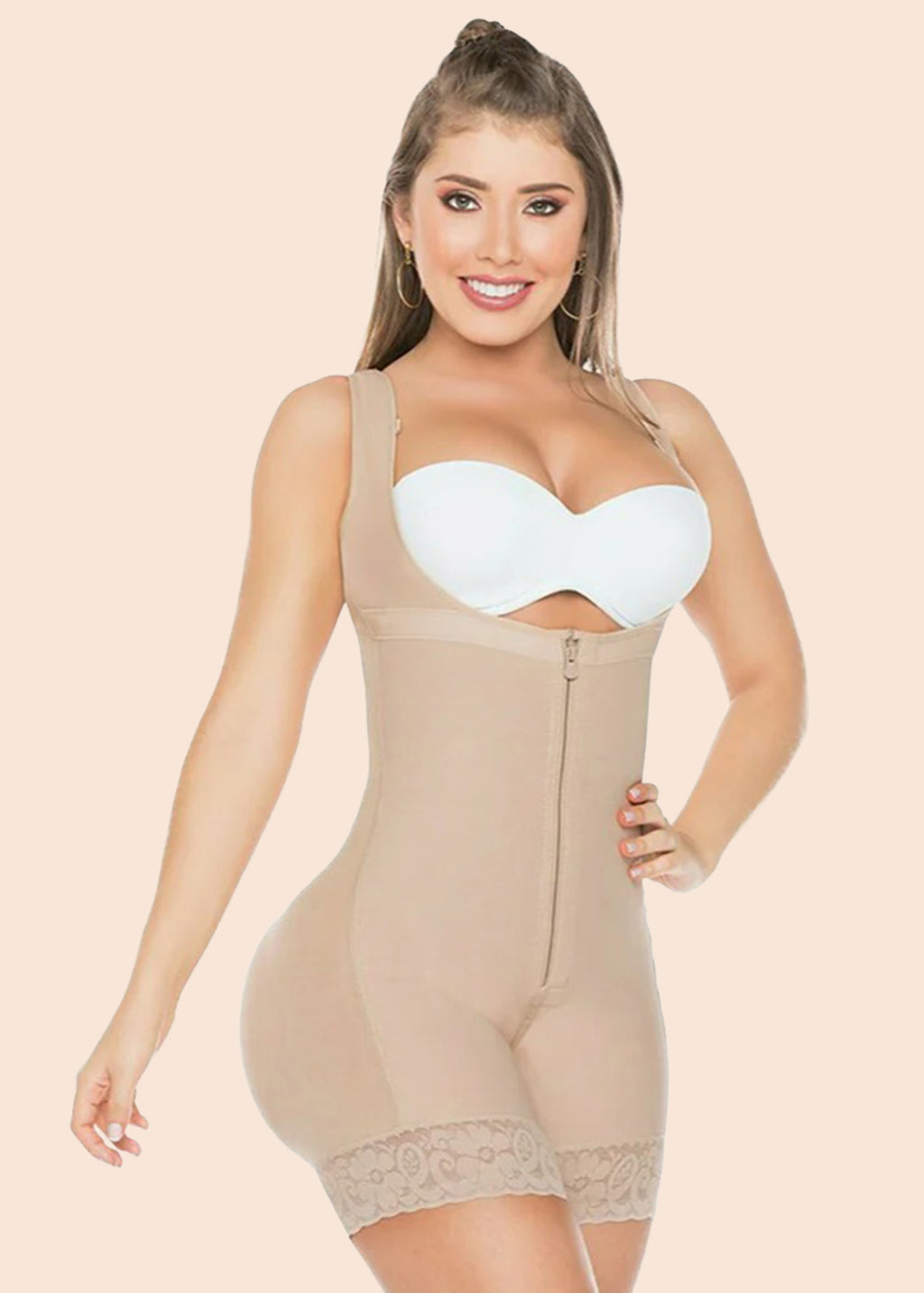 Woman wearing a beige shapewear bodysuit on a beige background