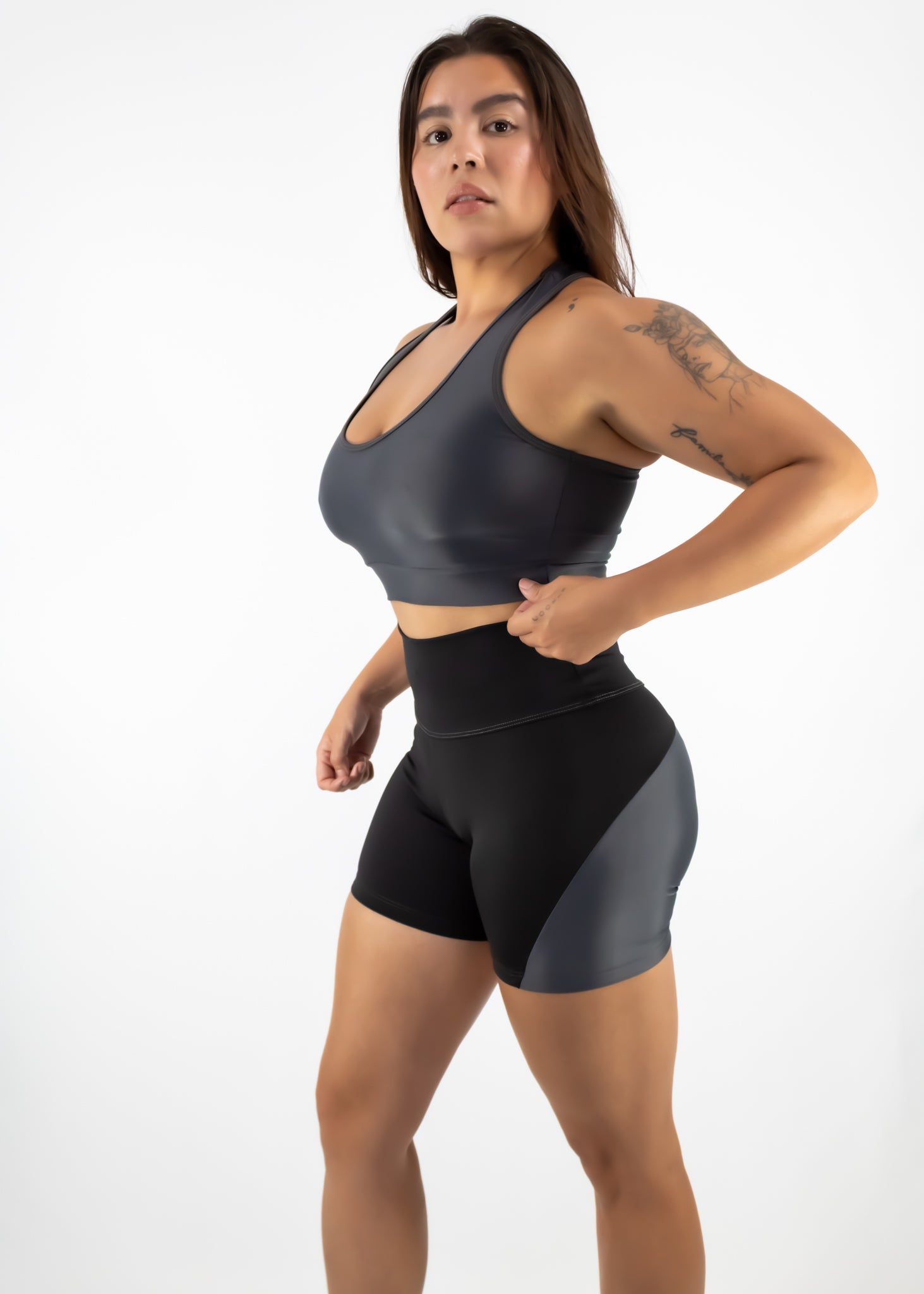 Person wearing a black athletic outfit on a white background