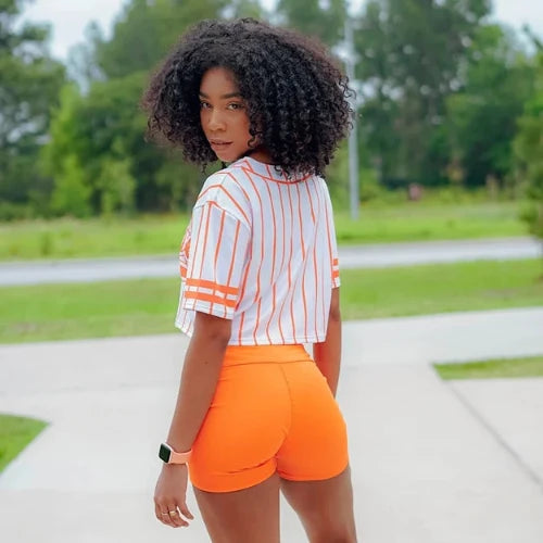 Close-up of the 'Shorts + Top Activewear Set (2 Piece)' featuring orange shorts and a white top