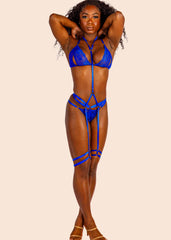 Woman wearing a blue lingerie set against a beige background