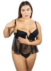 Woman wearing a black lingerie set with sheer overlay on a white background
