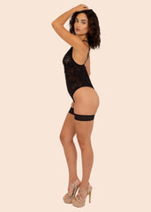 woman wearing a black bodysuit posing on left side