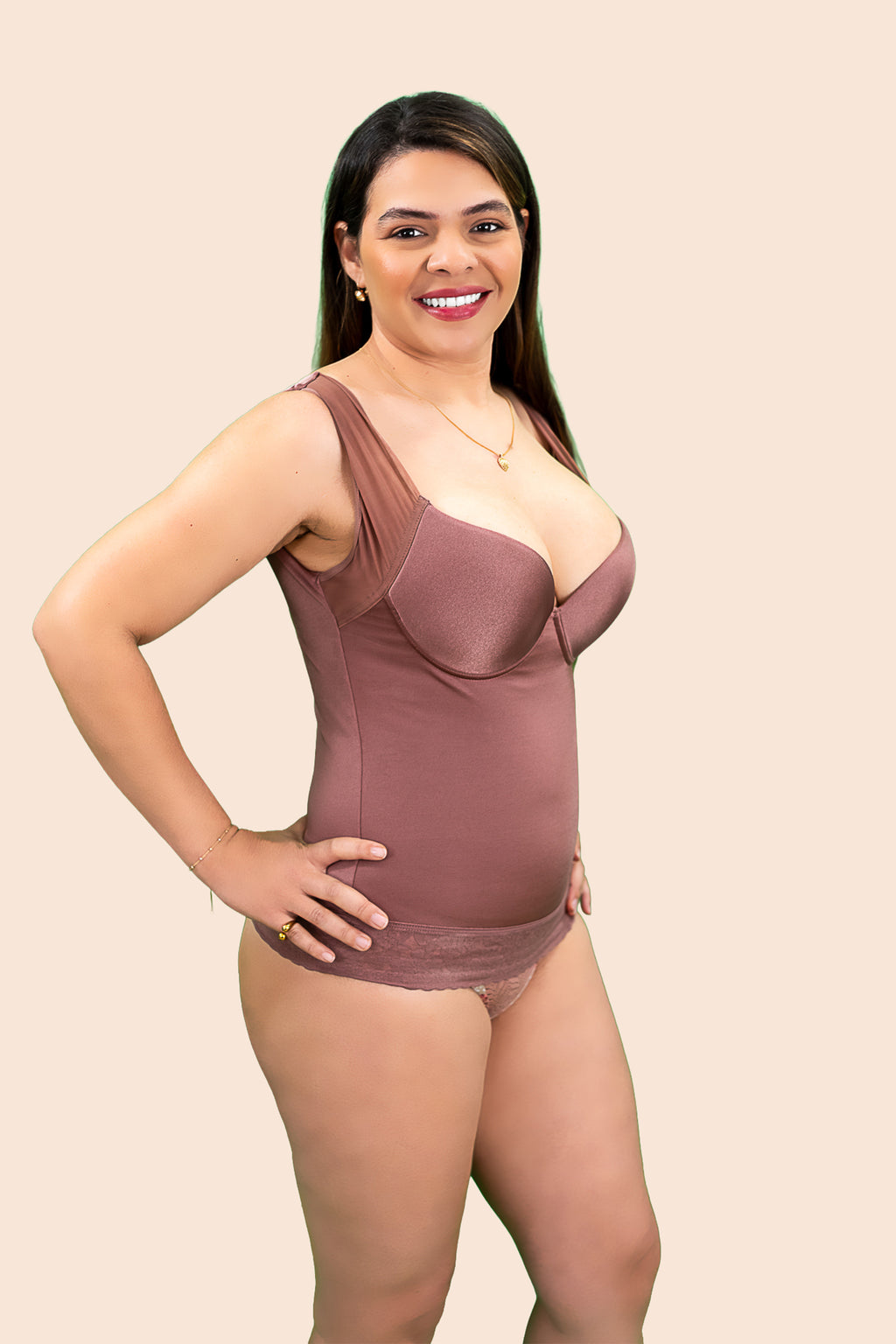 Woman wearing a brown bodysuit against a beige background
