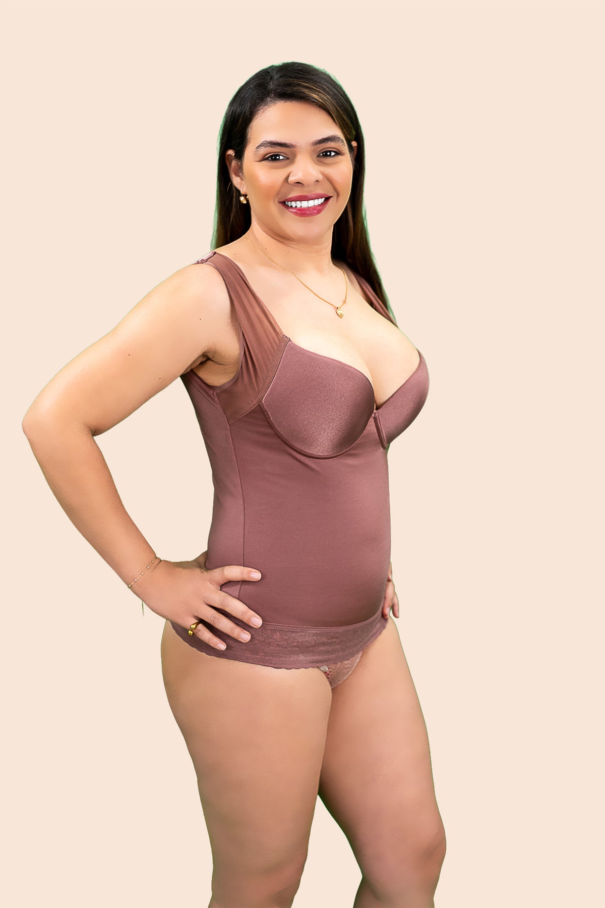 Woman wearing a brown bodysuit against a beige background