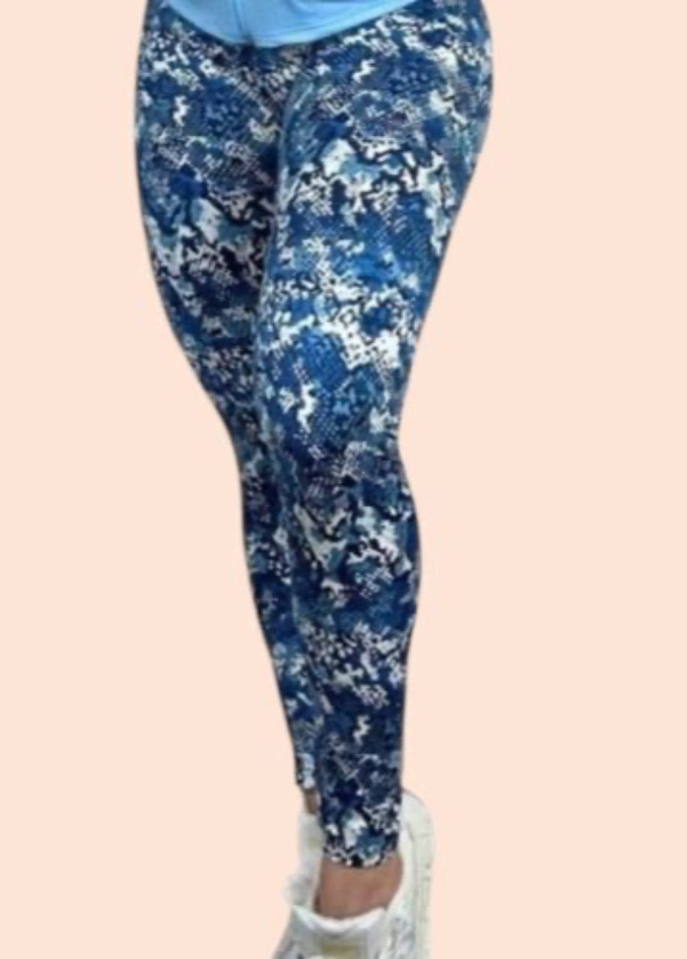 Blue floral leggings worn by a person on a beige background