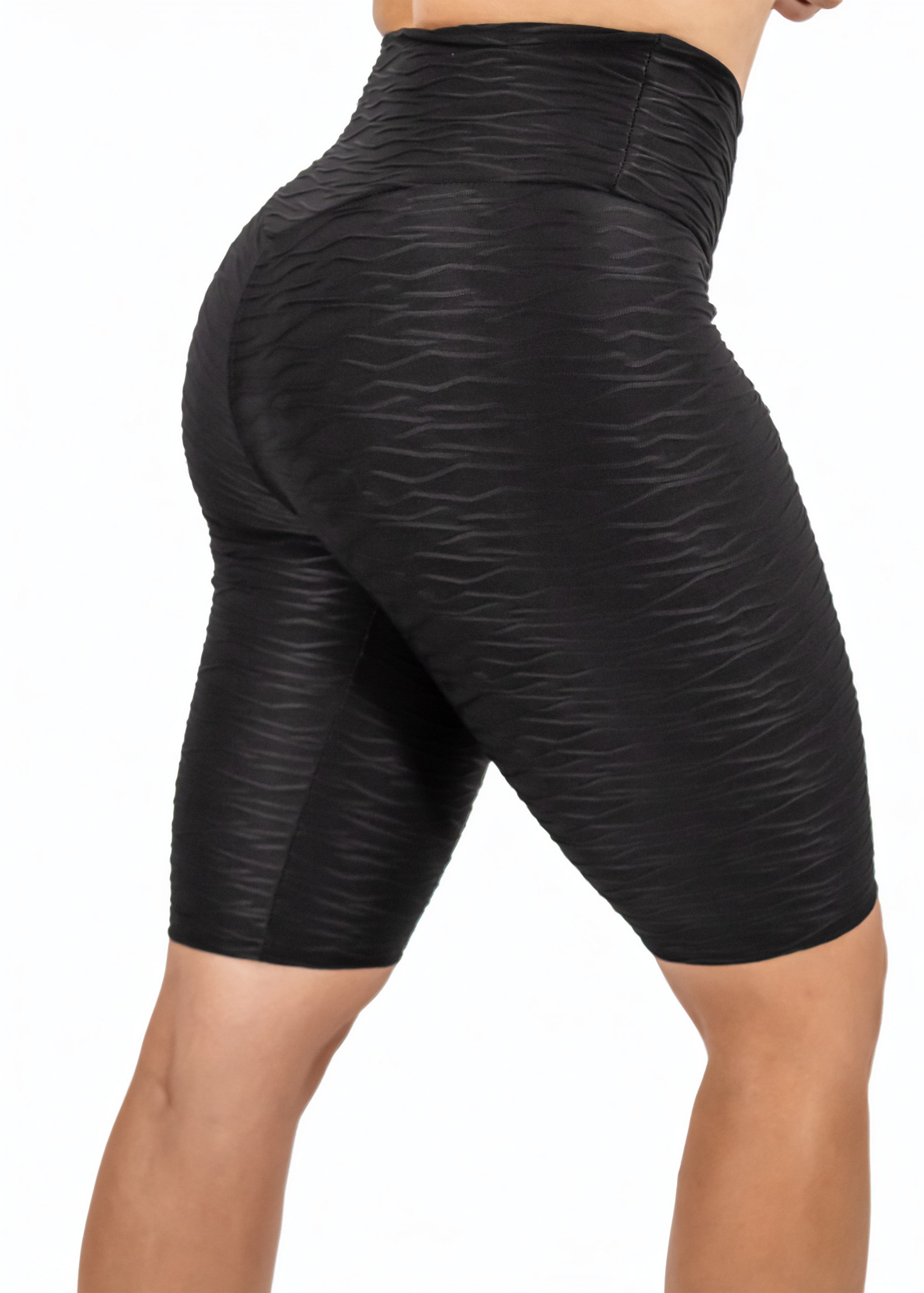 Black patterned shorts worn by a person on a white background