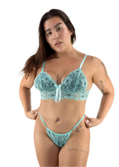 Woman wearing a teal lace lingerie set on a white background