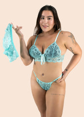 Woman wearing a turquoise lace lingerie set on a beige background
