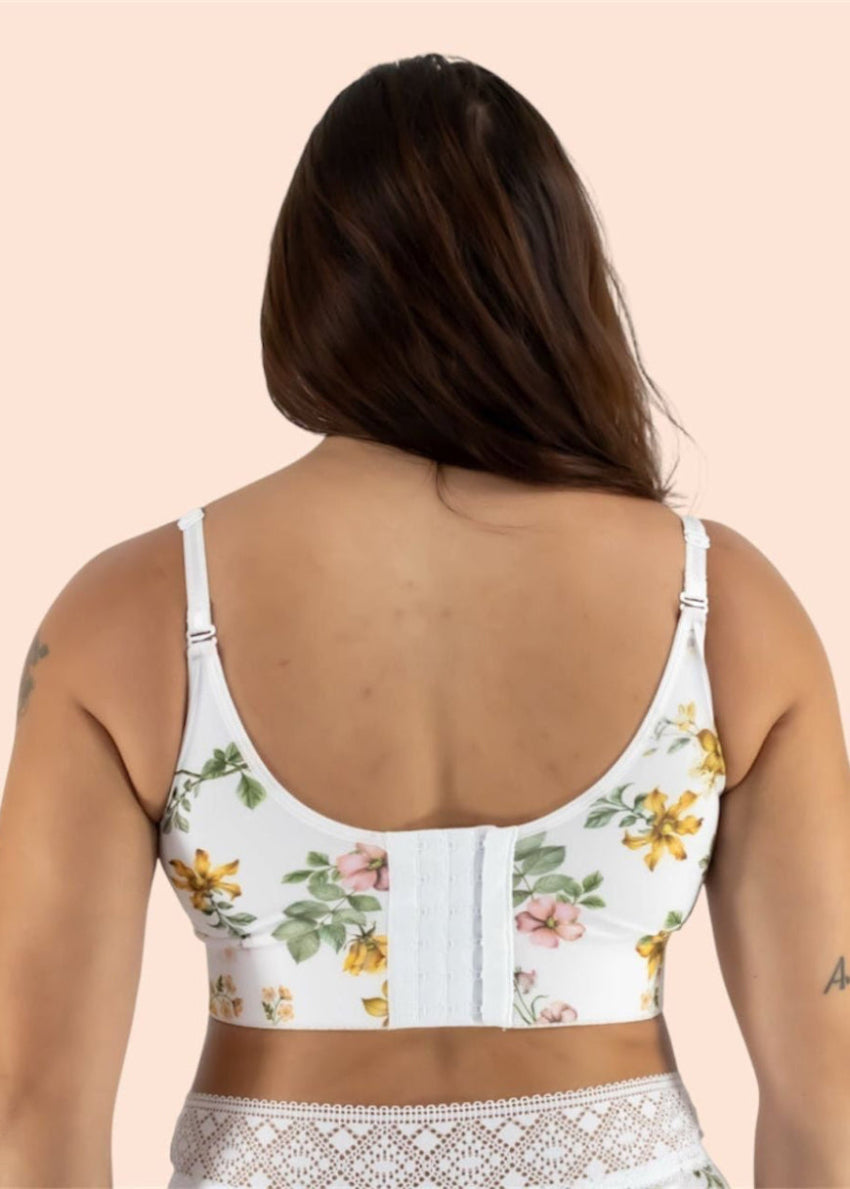 Woman wearing a floral-patterned top on a beige background