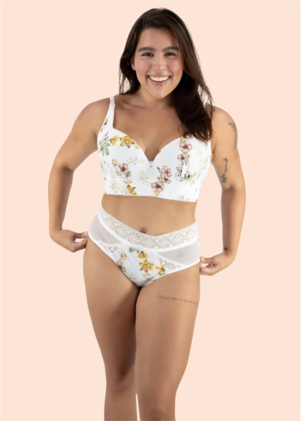 Woman wearing a floral white bra and panties set on a beige background