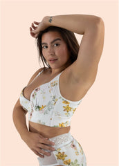 Woman wearing a floral two-piece outfit on a beige background