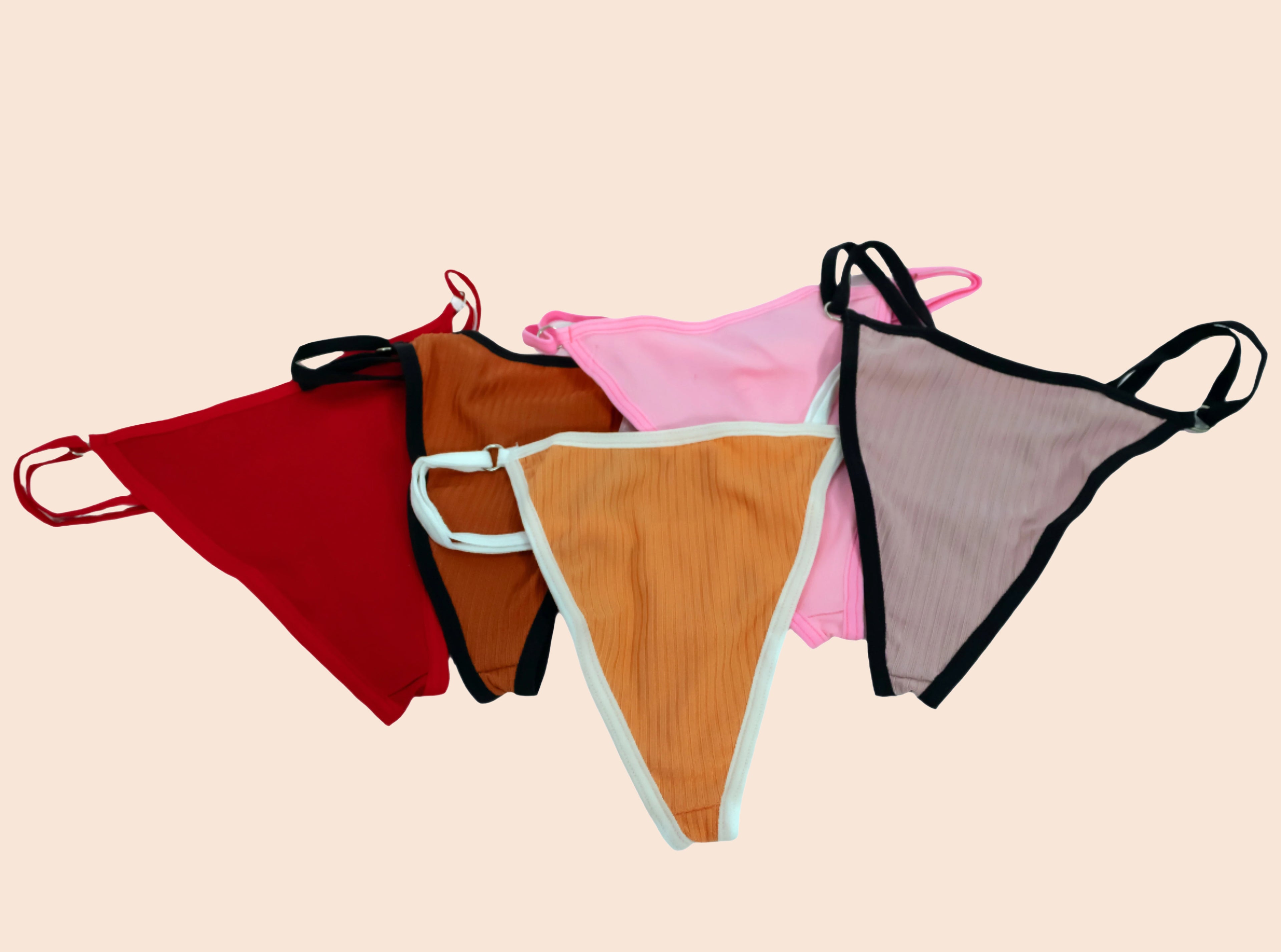 Four pairs of colorful underwear on a beige background