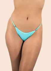 Turquoise bikini bottom on a beige background
