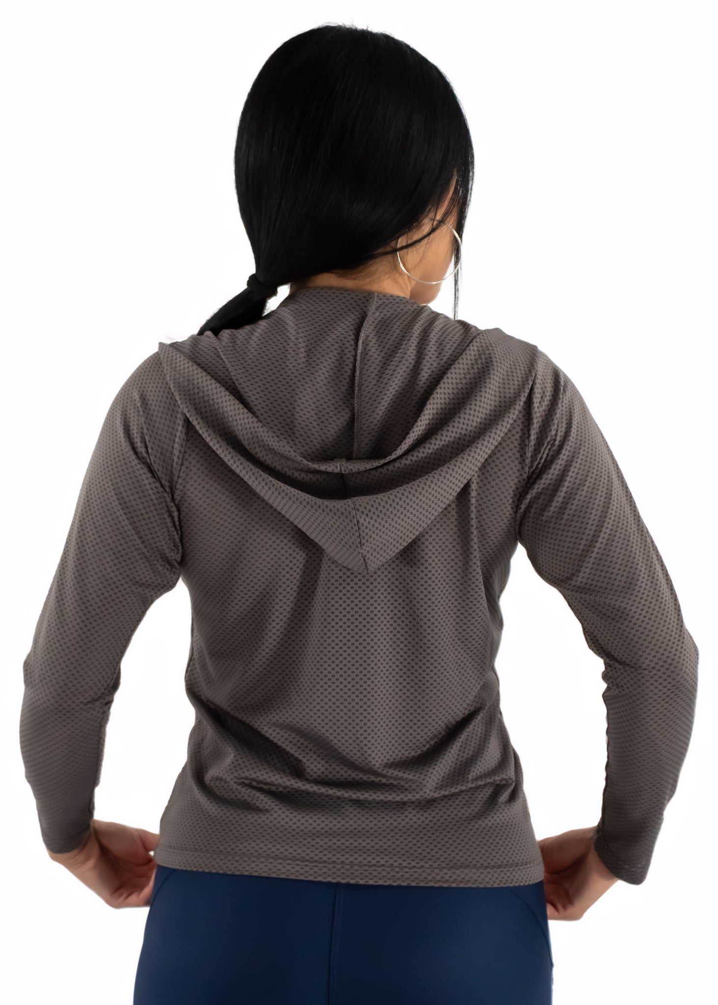 Woman wearing a brown textured hoodie on a white background