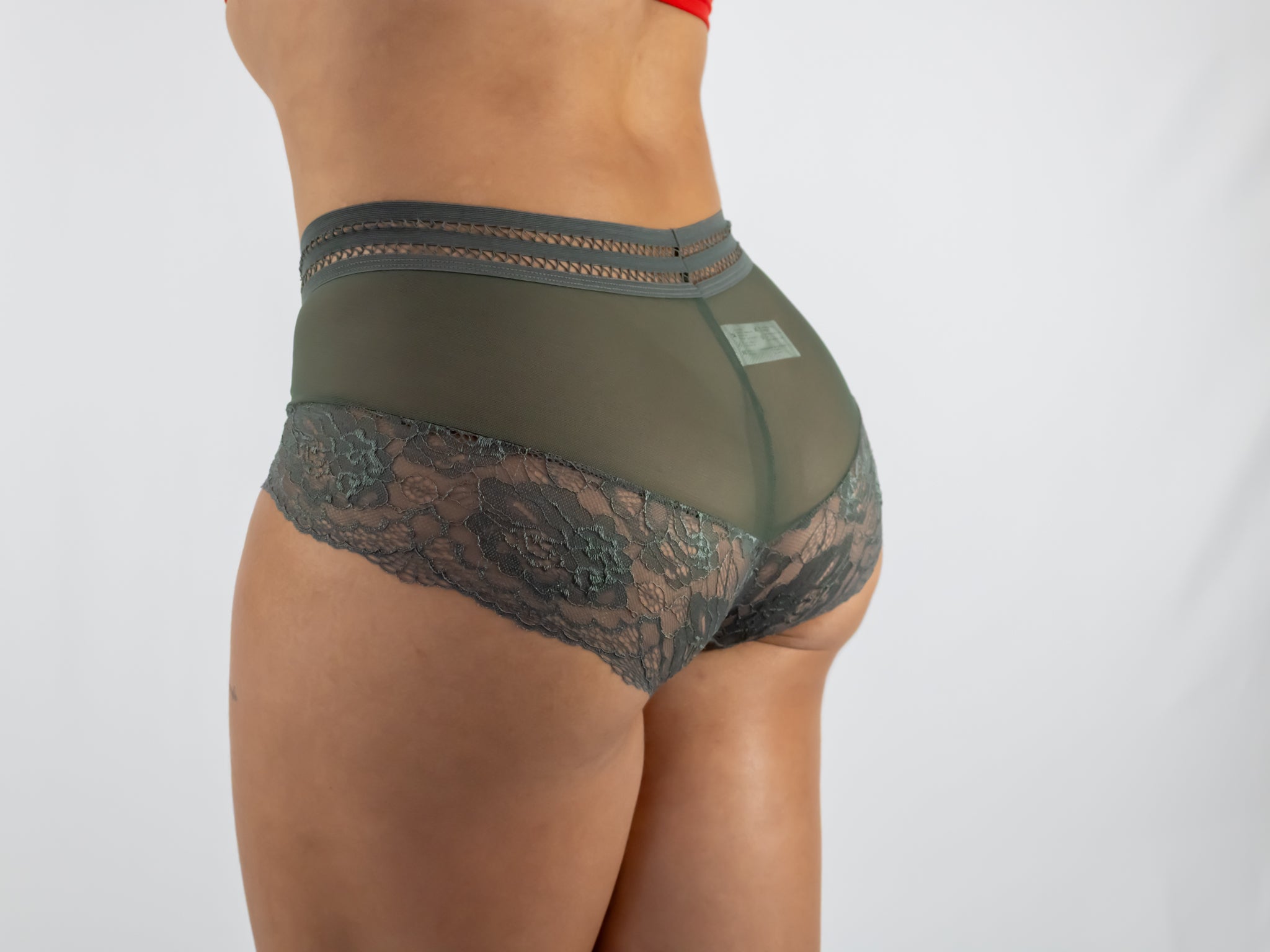 Green lace underwear on a plain background