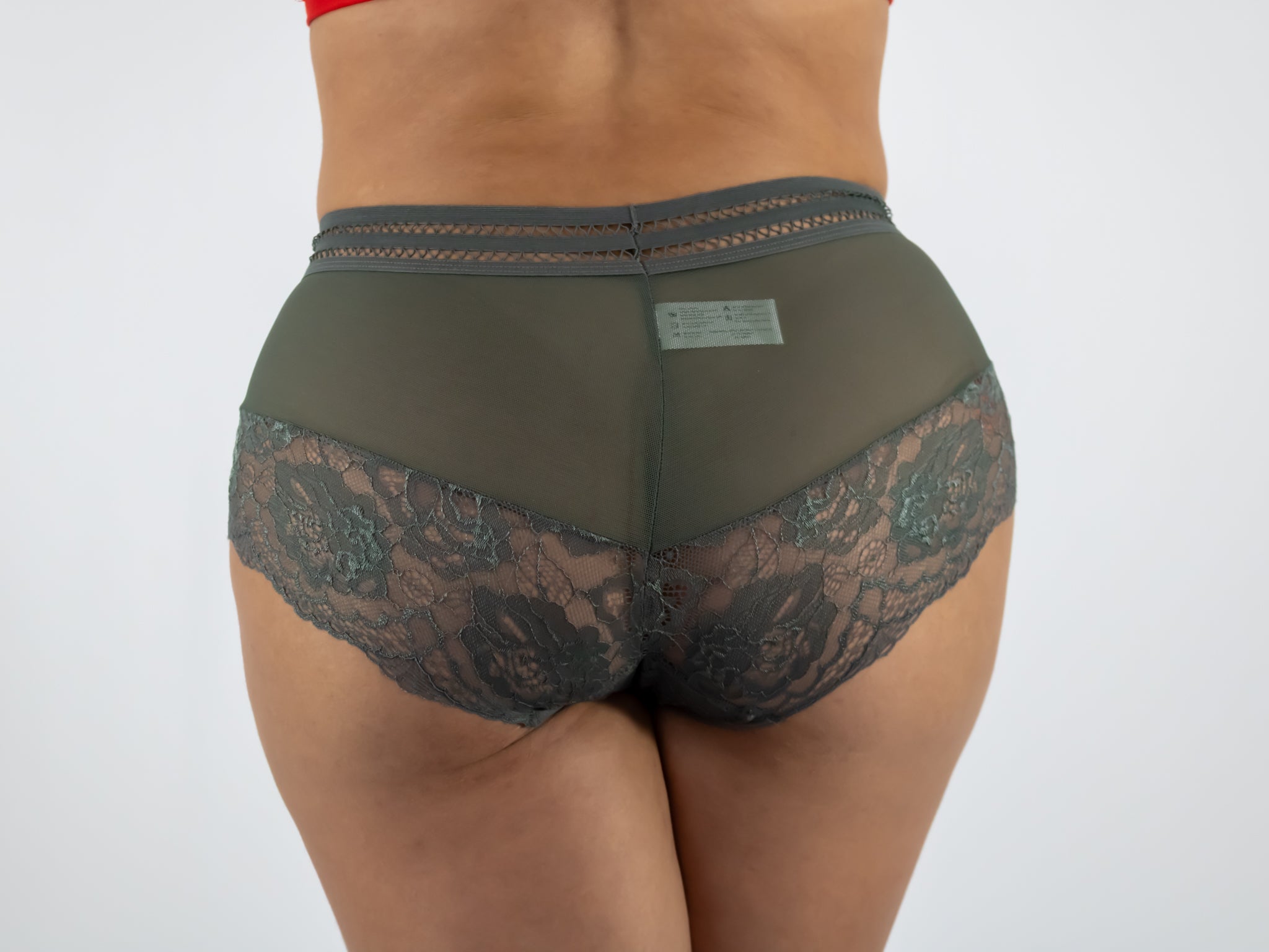Green lace underwear on a plain background