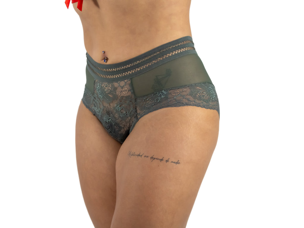 Green lace underwear worn by a person on a white background