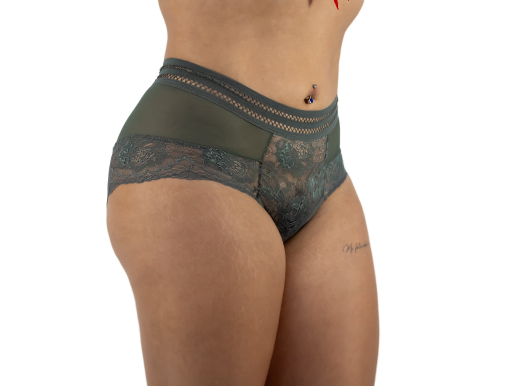 Person wearing green lace underwear on a plain background