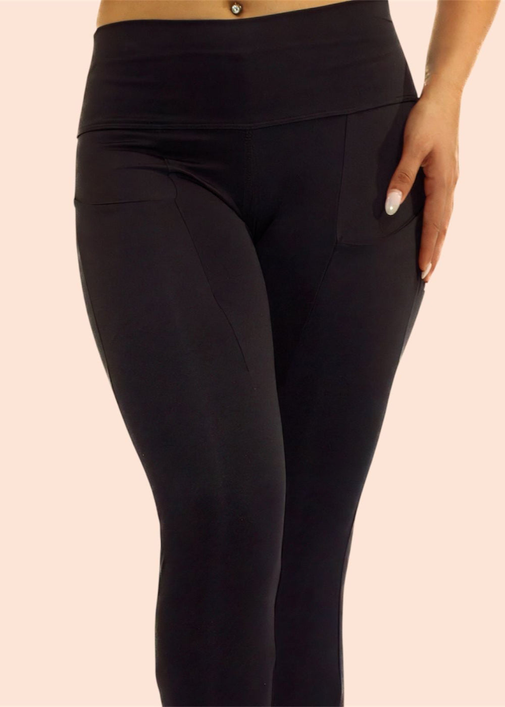 Black leggings worn by a person on a beige background