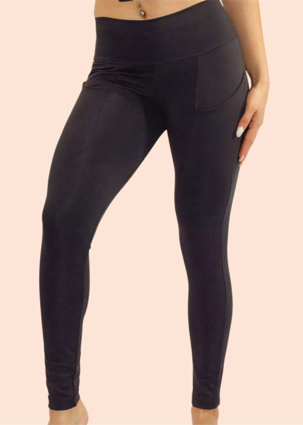 Black leggings worn by a person on a beige background