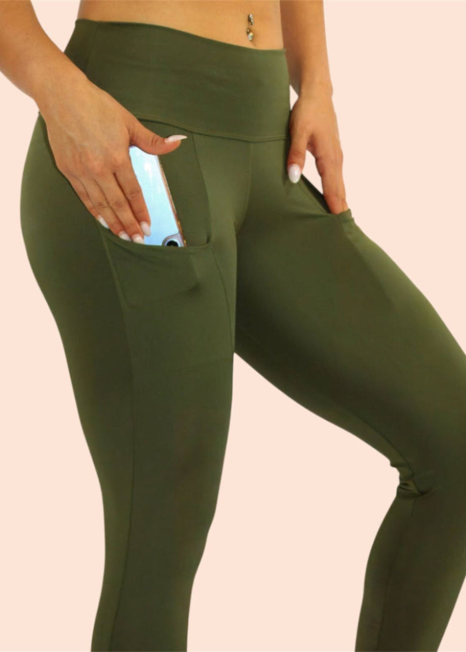 Green leggings with a pocket on a beige background