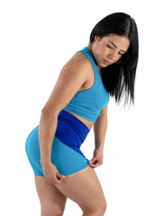 Woman wearing a blue athletic outfit on a white background