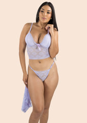 Woman wearing a light purple lingerie set on a beige background