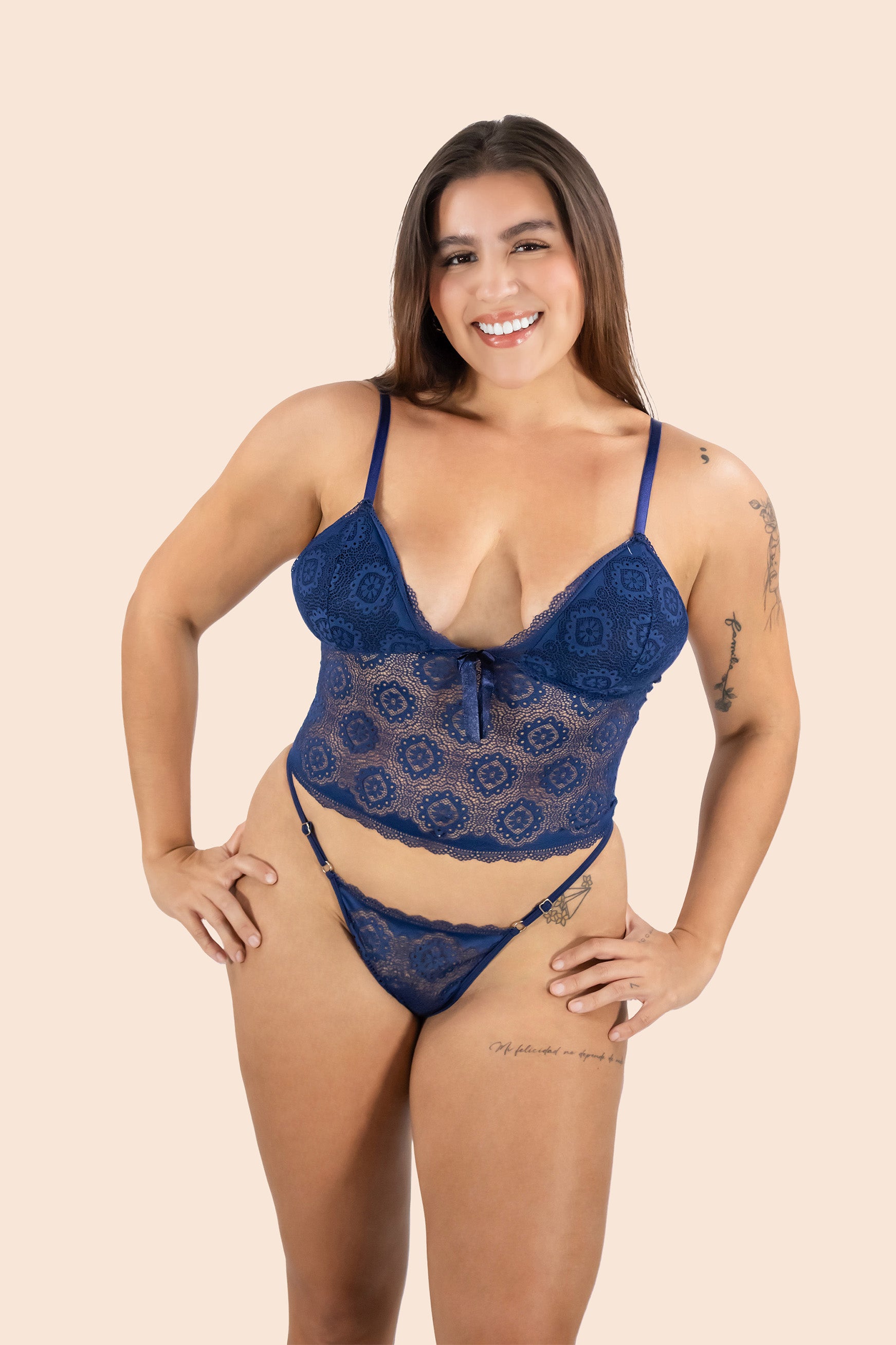 Woman wearing a blue lace lingerie set on a beige background