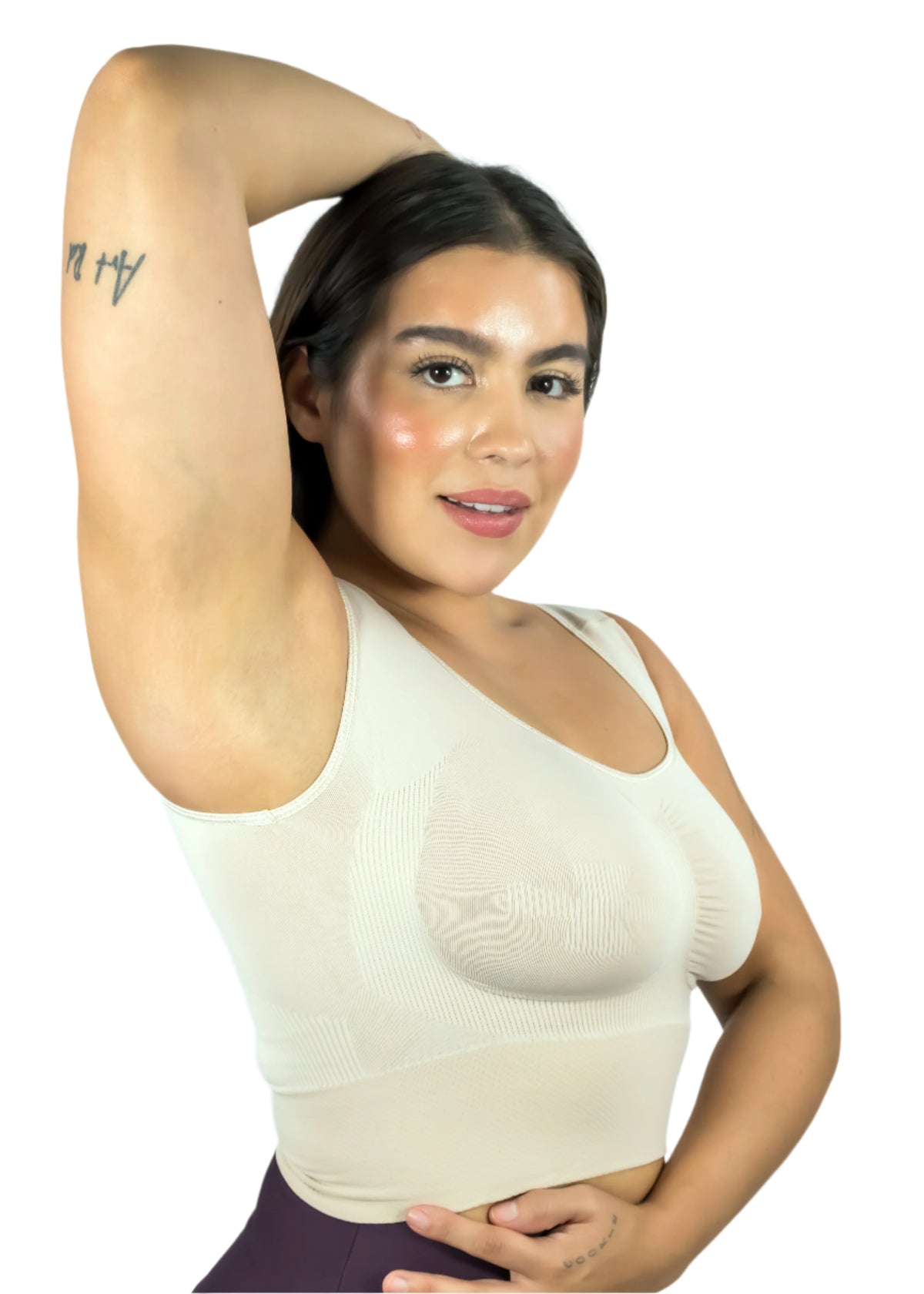 Woman wearing a beige tank top against a light gray background