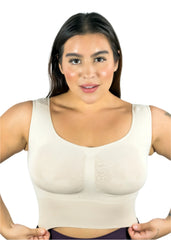 Woman wearing a beige compression garment against a light blue background