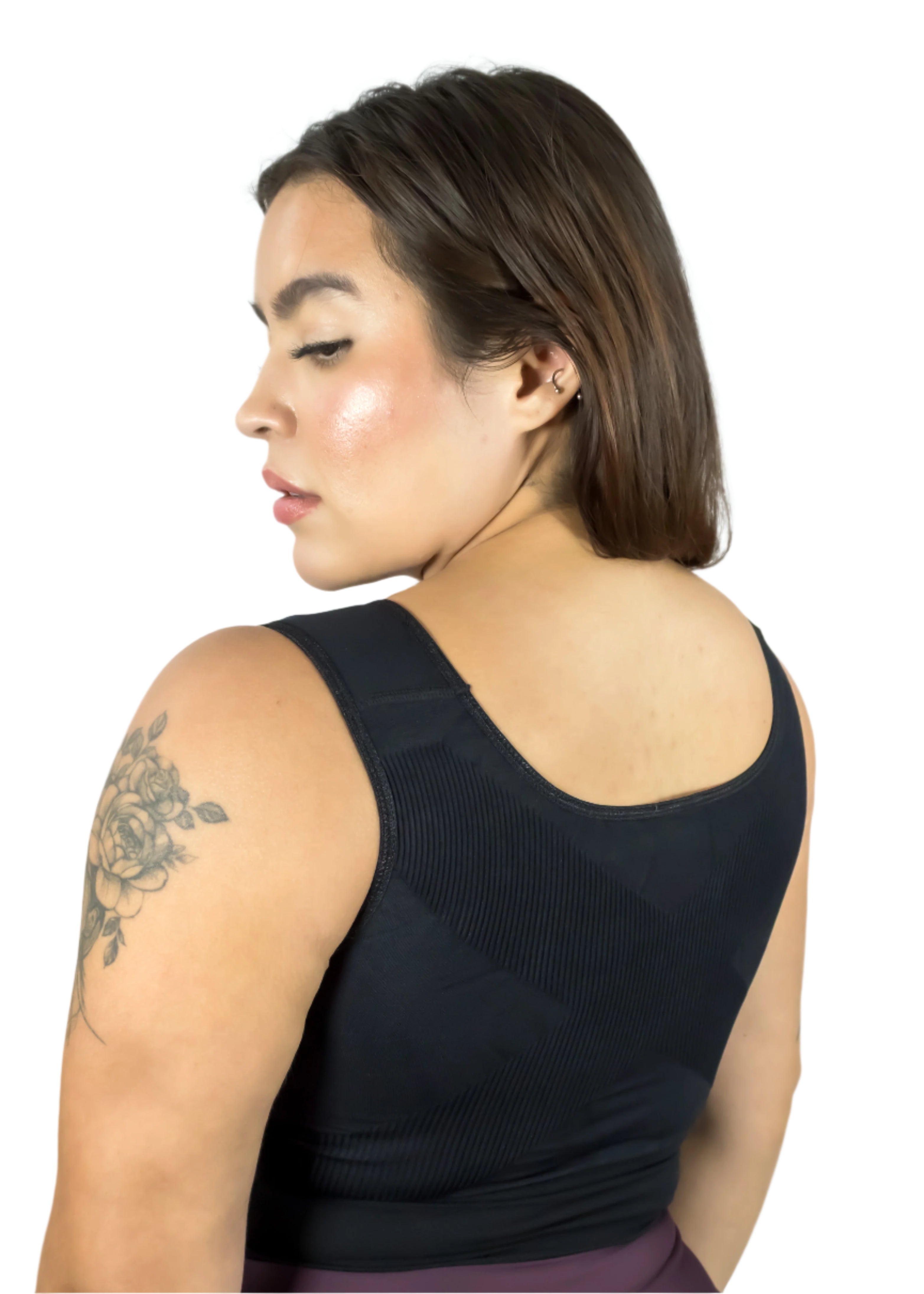 Woman wearing a black sleeveless top against a light gray background