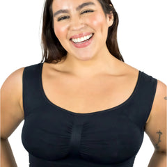 Woman wearing a black sleeveless top against a white background