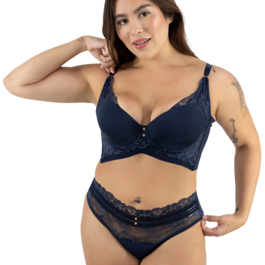 Woman wearing a navy blue lace lingerie set on a white background