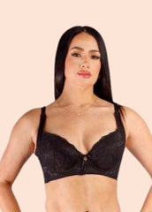 Woman wearing a black bra against a beige background
