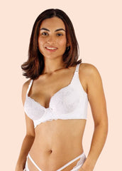 Woman wearing a white bra and panties set on a beige background