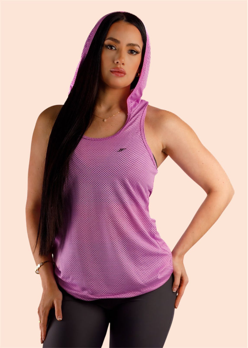 Woman wearing a purple hooded tank top on a beige background