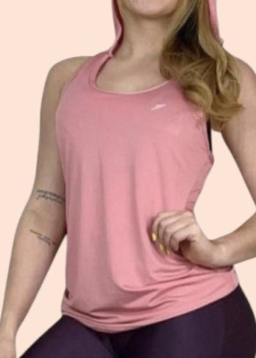 Person wearing a pink tank top with a brand logo on a light pink background