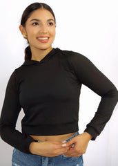 Woman wearing a black long-sleeve crop top with mesh panels on a white background