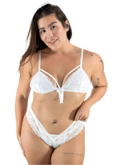 Woman wearing a white lace lingerie set on a plain background