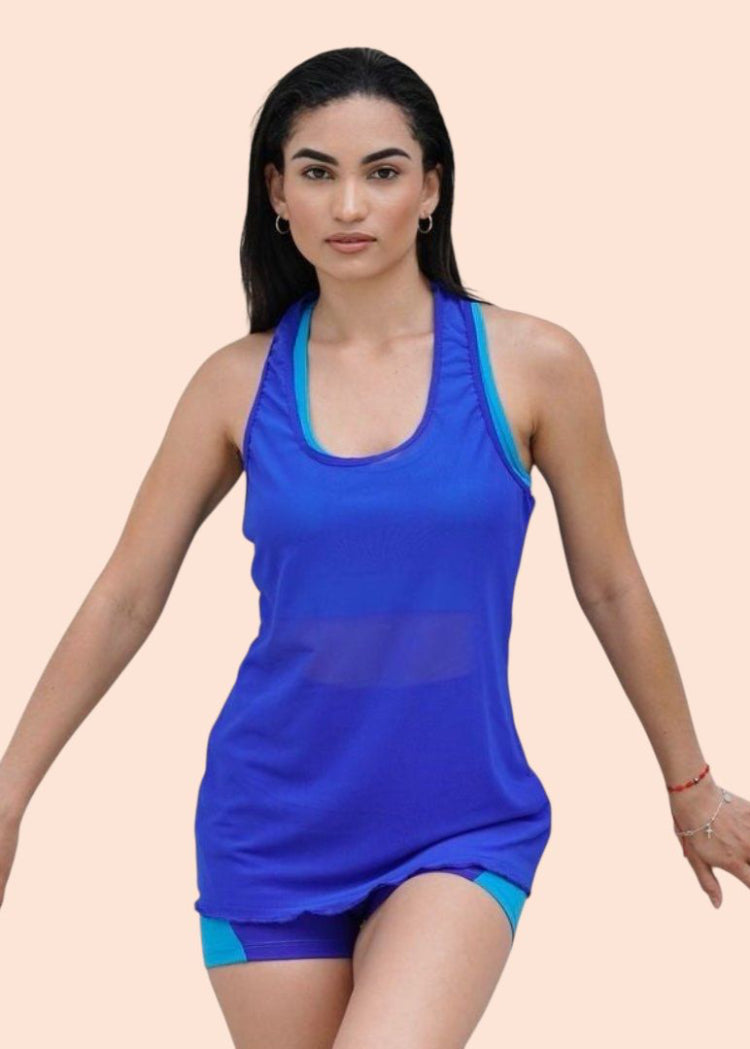 Woman wearing a blue athletic outfit on a beige background