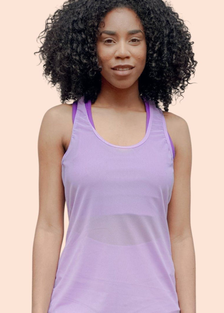Woman wearing a purple tank top against a beige background