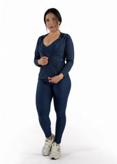 Woman wearing a navy blue athletic outfit on a white background