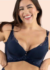 Woman wearing a navy blue bra against a beige background