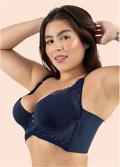 Woman wearing a navy blue bralette against a beige background