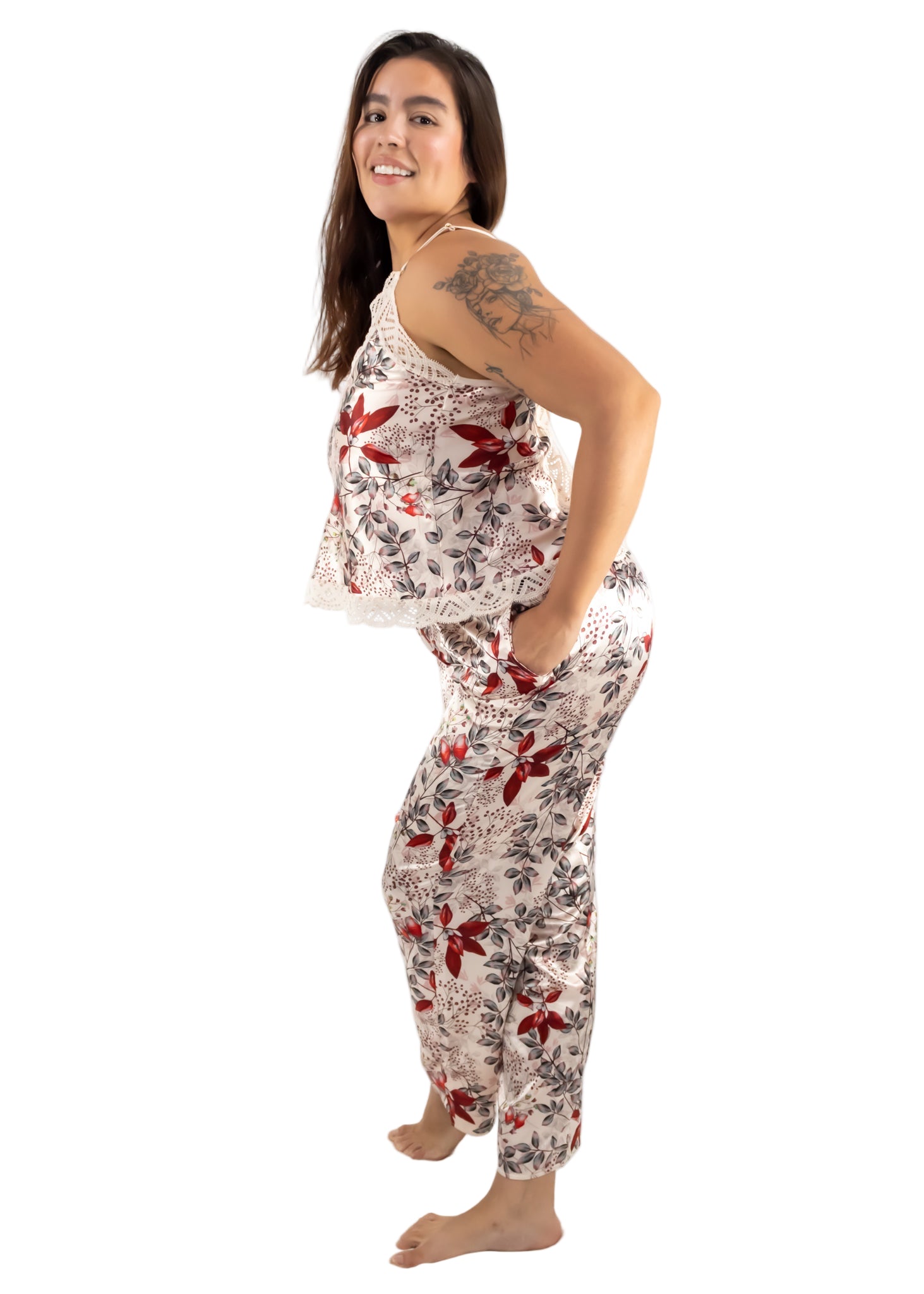 Woman wearing a floral pajama set on a white background